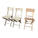 A set of three folding garden chairs with slatted backs & seats, raised on rectangular frames joined