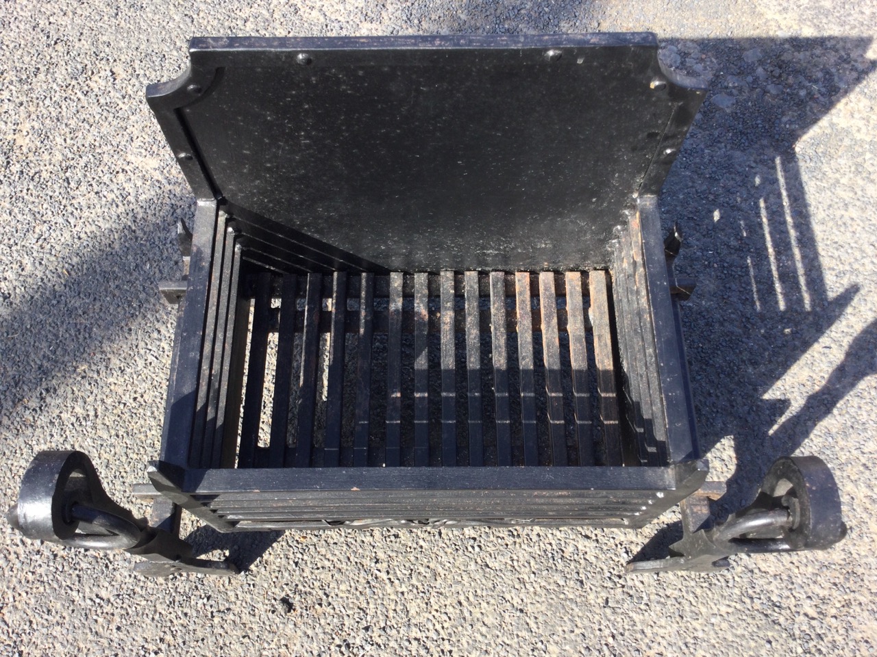 An C18th style cast iron firegrate, with panelled fireback and basket grate supported on fire dogs - Image 3 of 3