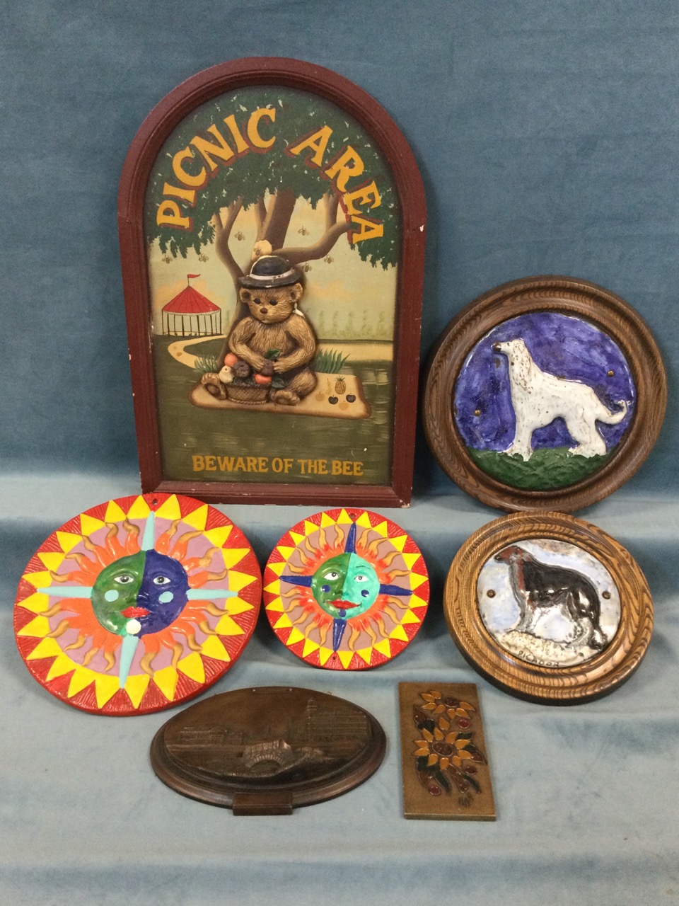 Miscellaneous wall plaques including two circular majolica glazed dogs in wood frames, a graduated