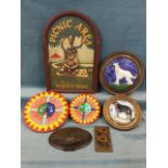 Miscellaneous wall plaques including two circular majolica glazed dogs in wood frames, a graduated