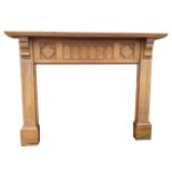 A large pine chimneypiece with rectangular moulded mantlepiece supported on fluted corbels, the