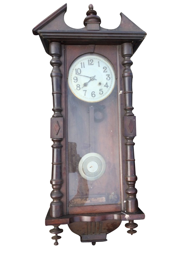 A stained Vienna wallclock with broken pediment framing a turned finial above an arched door flanked