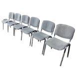 A set of six stacking upholstered chairs with rounded backs and seats on rectangular angled legs. (