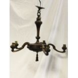 A copper hanging light fitting having column hung from short chain from ceiling rose, the bun shaped