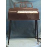 A 60s electric keyboard on tapering ebonised legs. (28in x 33in x 11in)