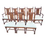 A set of eight oak Old Charm dining chairs, the backs with gothic carved panels in ribbed rails,