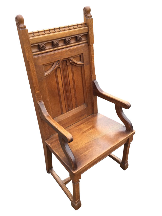 A late Victorian oak armchair with dentil moulding to back rail above a frieze mounted with carved