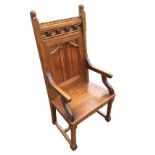 A late Victorian oak armchair with dentil moulding to back rail above a frieze mounted with carved