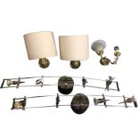 A pair of brass wall lights with curved shades; a pair of ceiling lights mounted rows of four