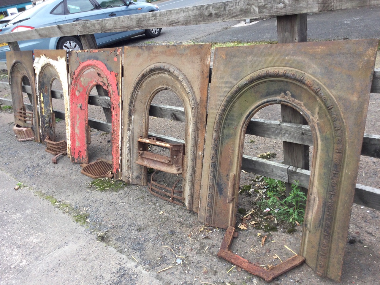 A set of three nineteenth century arched cast iron fire inserts with flowerhead embossed castings; a - Image 3 of 3