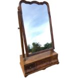 A Queen Anne style walnut dressing table mirror, the scalloped frame on tapering column supports