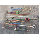 Miscellaneous garden tools including forks, a spade, choppers, an edger, hoes, shears, a rake,