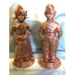 A pair of cast iron lustre enamelled Dutch boy & girl figures, with fire-tools to backs. (20in) (2)