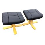 A pair of faux leather angled stools with panelled upholstered seats on bentwood supports with