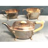 A hallmarked silver three-piece teaset with rectangular rounded bodies raised on moulded legs to