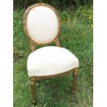 A Louis XV style hall chair with oval upholstered back in leaf carved frame above a sprung seat,
