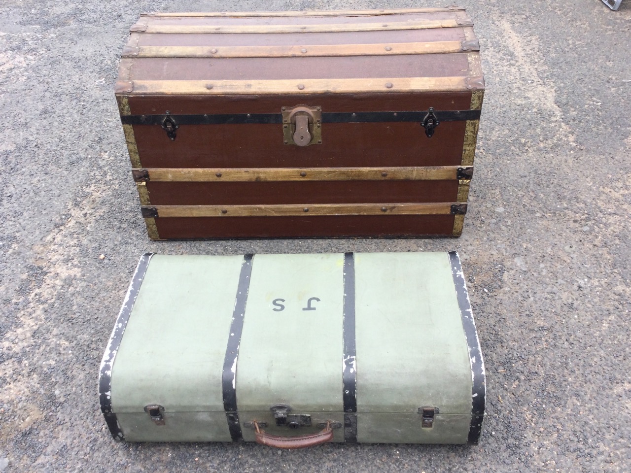 A canvas covered wood motoring trunk, the rounded case with leather handle and painted metal mounts;