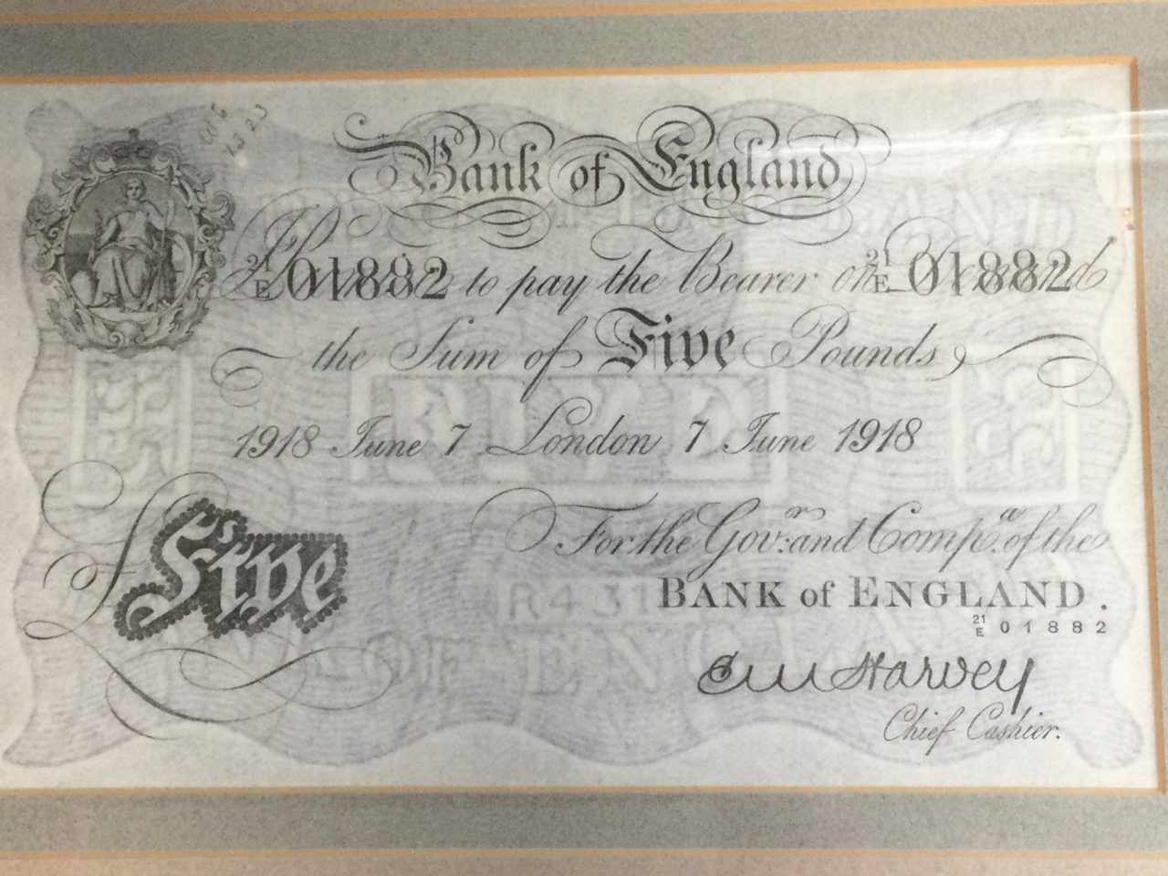 A 1918 £5 note, the watermarked paper mounted & walnut framed. (8in x 5in)