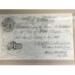 A 1918 £5 note, the watermarked paper mounted & walnut framed. (8in x 5in)