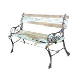 A rectangular painted garden bench with slatted wood back & seat on cast iron scrolled ends with