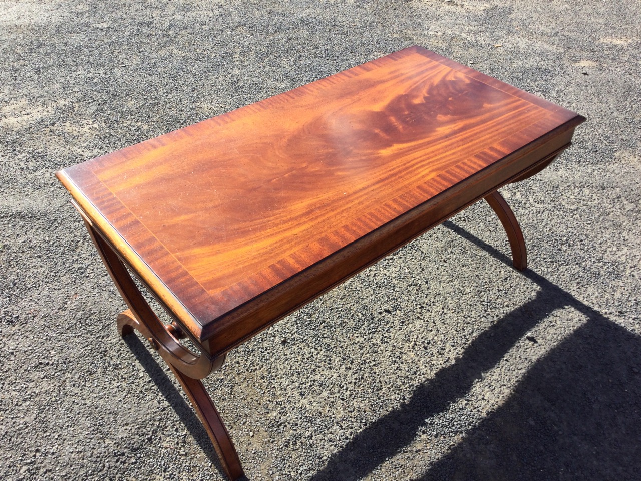 A rectangular mahogany coffee table, the crossbanded moulded top with plain apron raised on cradle - Image 2 of 3