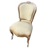 A nineteenth century Louis XV style chair with shield shaped upholstered back in moulded frame