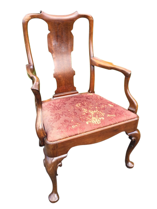 A nineteenth century Queen Anne style walnut armchair with wide shaped splat beneath a scroll carved