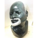 A heavy carved and polished stone African bust. (17in)