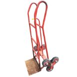 A three wheel adjustable sack barrow with tubular metal frame.