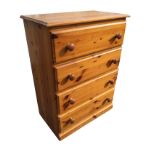 A reproduction pine chest of drawers with rectangular moulded top above four knobbed drawers. (