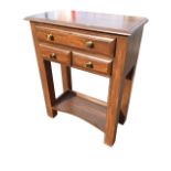 A rectangular contemporary hall table with moulded top above a long drawer and two small drawers,