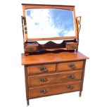 A late Victorian walnut dressing table, the back with arched bevelled mirror above a serpentine