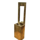 An art nouveau style brass wall pocket with rectangular frame to mirror above an open box, the brass