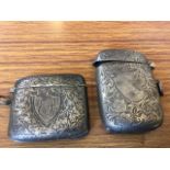 Two Birmingham hallmarked silver vestas with floral scroll embossed decoration, each mounted with