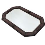 A rectangular octagonal mirror with bevelled plate in bead moulded frame, having applied roundels