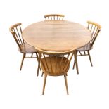An elm Ercol dining room table & chair set, the circular table with two drop-leaves on angled
