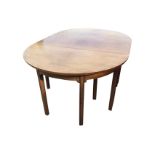 A nineteenth century mahogany dining table in three sections, the top with rounded ends raised on