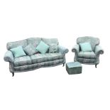 A three-seater sofa and armchair, the chairs with arched backs and loose cushions, having sprung