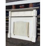 A painted chimneypiece with moulded mantelpiece above a frieze with applied swagged & ribbon bow