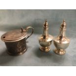 A cased pair of silver pepperettes with tapering bodies on cup bases - Birmingham; and an early