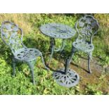 A rose embossed garden table, sunshade stand and pair of chairs, the verdigris patinated pieces with