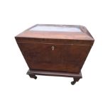 A nineteenth century mahogany cellarette of sarcophagus shape, the rosewood crossbanded top