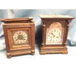 An Edwardian oak cased mantle clock having silvered dial with applied brass spandrels under arched