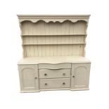 A painted Victorian pine dresser, the back with moulded cornice above open grooved shelves with