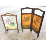 An art nouveau two-fold firescreen pyrography decorated with swallows & lilies; and another oak