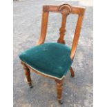 A late Victorian aesthetic oak chair, the back with arched carving having chisel carved line