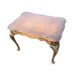 A rectangular mahogany coffee table, the scalloped top above waved aprons, raised on cabriole legs