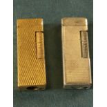 A Dunhill silver plated Swiss made rollagas cigarette lighter with engine turned decoration to