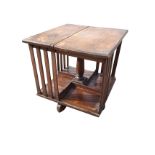 A square mahogany revolving table bookcase, with slats framing four sections, supported on turned