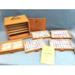 A cased mahjong set, the pieces contained in five drawers within a dovetailed mahogany box with